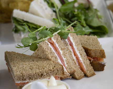 A plate of smoked salmon sandwiches. 
