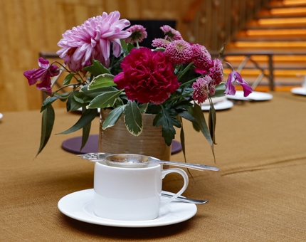 An arrangement of flowers and a coffee in Fingal Hotel's Ballroom.