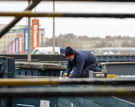 A Maintenance team member fixing a roof to a new container in the compound.