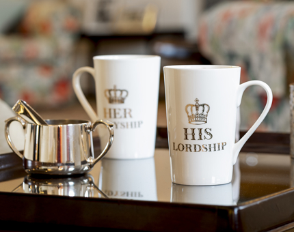 Two white mugs. One says his lordship, the other, her ladyship. 