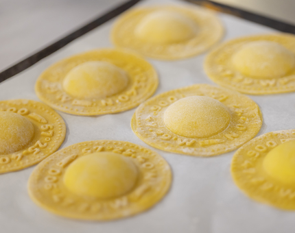 A closer up of a tray of finished ravioli.