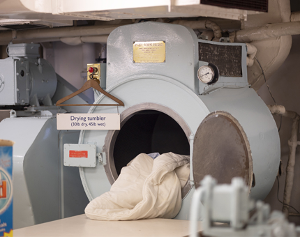 A washing machine in the onboard Laundry. 