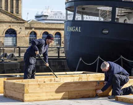 Two Facilities Officers preparing the herb garden outside Fingal Hotel. 