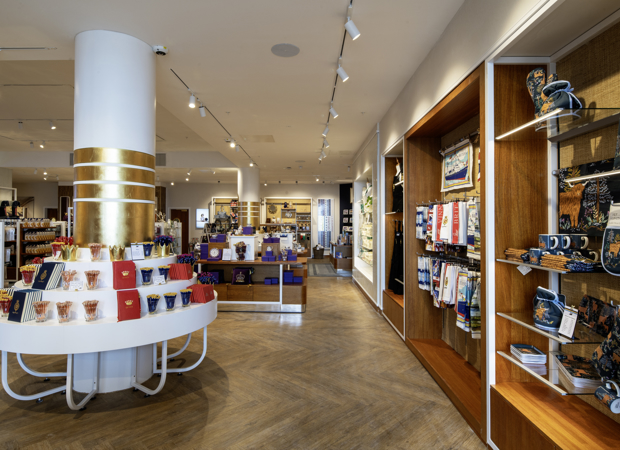 Inside the new Britannia Shop. There are many different displays included tables, a round pillar with shelves and wall-mounted displays containing souvenirs and gifts. 