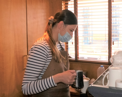 Prepares a specialty coffee in The Lighthouse Restaurant & Bar.