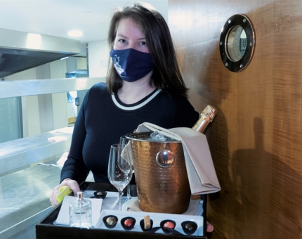 Guest Relations Duty Manager, Morven, prepares to add a special treat to a guests cabin.