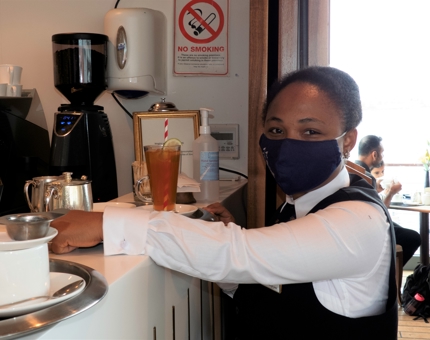 Prepares to serve a selection of drinks in the Royal Deck Tearoom.