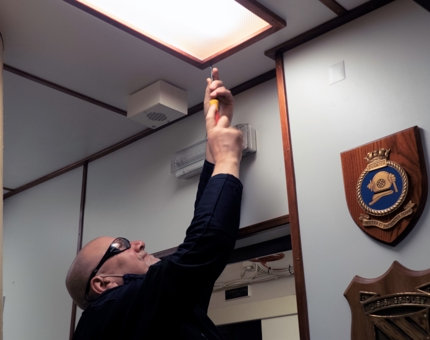 Changing a light in the Unwinding Room Bar.