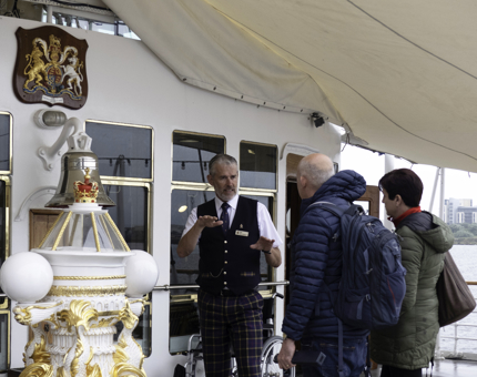 A Visitor Assistant talking to visitors. 