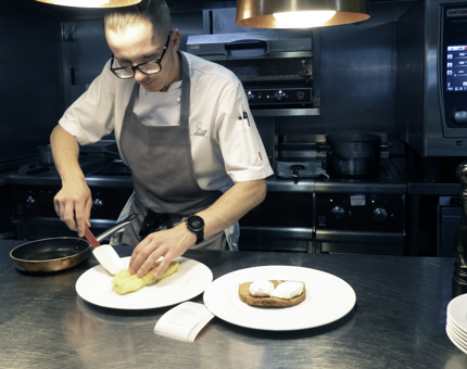 A Chef plating an omelette in the Galley at Fingal. 