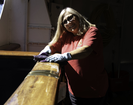 Eileen, Housekeeper, polishing handrails