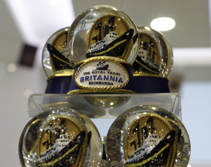 A shop display stand containing several Britannia glitter snowglobes. 