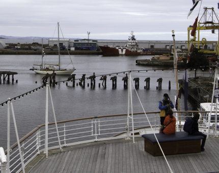 View out towards Leith Harbour from Britannia's outside Veranda deck where a sailing boat is coming into Port. 