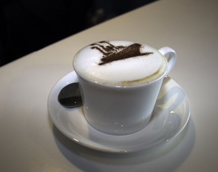 Cappuccino decorated with Britannia ship logo foam design. 