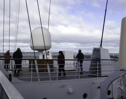 Visitors stand outside on Britannia's Bridge listening to audio guides. 
