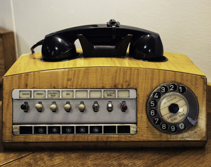 An original telephone handset with dial and switches.