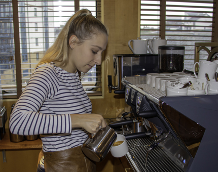 A Waiter makes an artisan coffee. 