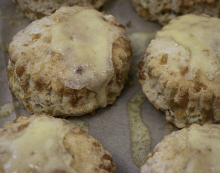 Freshly baked cheese scones on a tray.