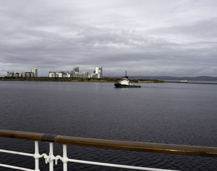 The view from Britannia's outside deck looking across the Firth of Forth with a small boat in the background.
