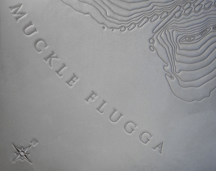 Close-up detail of headboard featuring 'Muckle Flugga' lighthouse. 