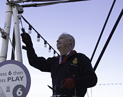 Maintenance man paints support poles on the Verandah Deck of Britannia.