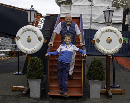 A man and a young boy standing on the steps of the Royal Brow. 