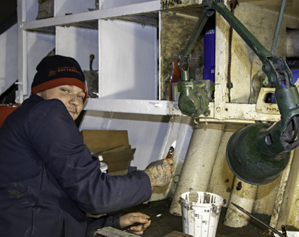 A man painting in the Engineers' Workshop. 