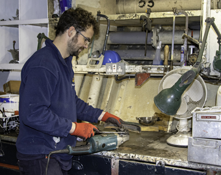A member of the Maintenance team removes the guard, ready to fit a new disc.