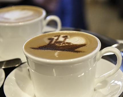 Cappuccinos with a Britannia chocolate stencil in the foam on top. 