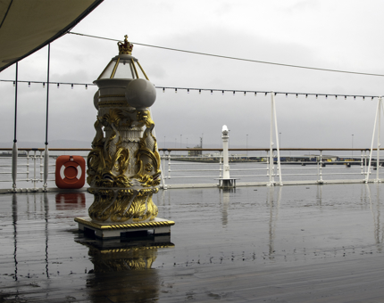 The gold compass pinnacle on the Verandah Deck on a rainy day.