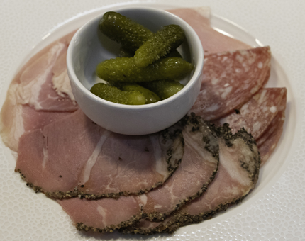 A charcuterie platter containing a selection of meats.