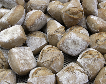 Close up of bread rolls on a cooling tray. 