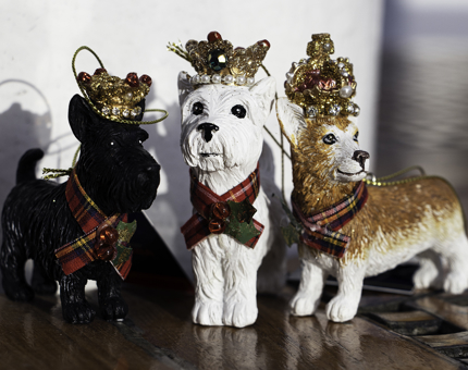 Three hanging dog decorations for the Christmas tree, black and white West Highland Terriers and a corgi.