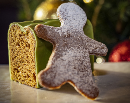 Close-up of gingerbread cake and a gingerbread man biscuit.