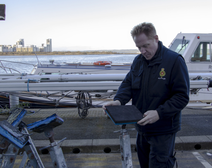 Small boat manager preparing stands for the Fast Motor Launch. 