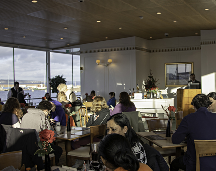 The view across the Royal Deck Tea Room with visitors sitting at tables. 