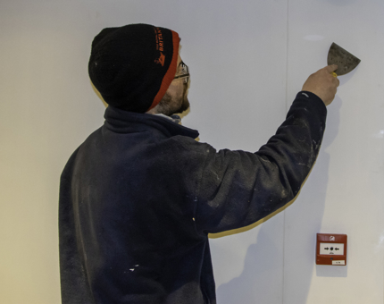 Maintenance team member fills holes on the bulkhead at Fingal. 
