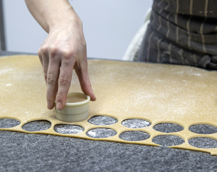 A Demi-Chef de Partie cuts out pastry rounds for Afternoon Tea. 