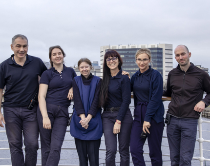 A group team photo of members of the Housekeeping Team at Fingal stand outside on deck.