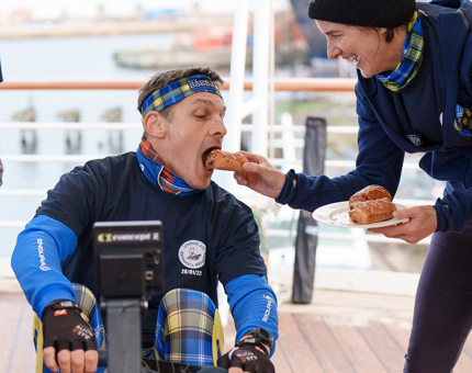 Dame Katherine Grainger gives a pastry to Scotland Rugby Captain and British and Irish Lion, Rob Wainwright. 