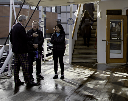 A Visitor Assistant sharing stories of Britannia's past standing out on deck. 