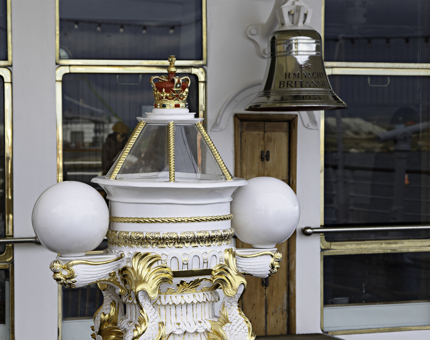 The top of the ornate compass binnacle and the Britannia Bell on the Verandah Deck. 