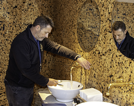 Man carrying out legionnaire testing of water temperature on board Fingal. 