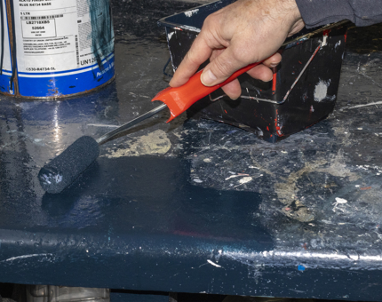 A close-up look of the painting roller on the workbench. 