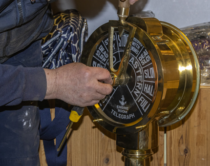 A close-up view of the telegraph in the Gift Shop as a member of the team attends to fixing it.