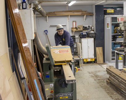 The planed handrails for Fingal are stacked up by a member of the team.