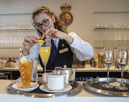 A Waiter preparing Bucks Fizz and Iced Tea drinks in the Royal Deck Tea Room. 