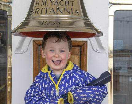 A young visitor has fun on board with a photograph at the Britannia Bell.