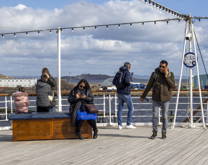 Visitors listen to their complimentary audio guide handset on the Verandah Deck.