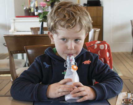 A young visitor enjoying a delicious milkshake in the Royal Deck Tea Room.